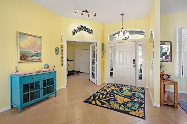 5688 Riverboat Cir SW, Vero Beach, FL 32968 - entrance foyer with a chandelier, tile patterned flooring, and baseboards