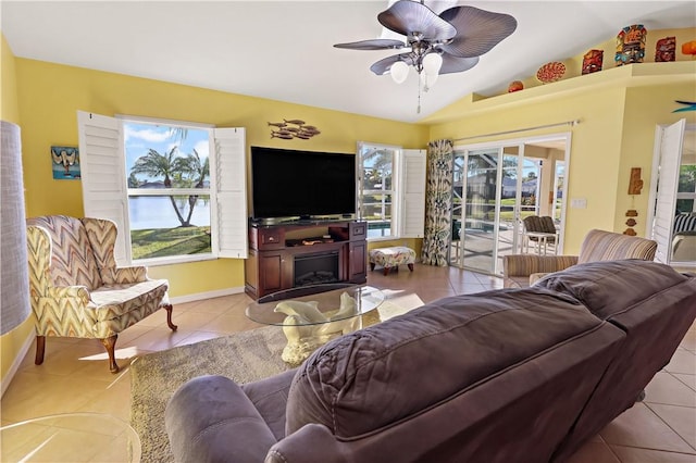 5688 Riverboat Cir SW, Vero Beach, FL 32968 - living area featuring plenty of natural light, light tile patterned floors, lofted ceiling, a ceiling fan, and baseboards