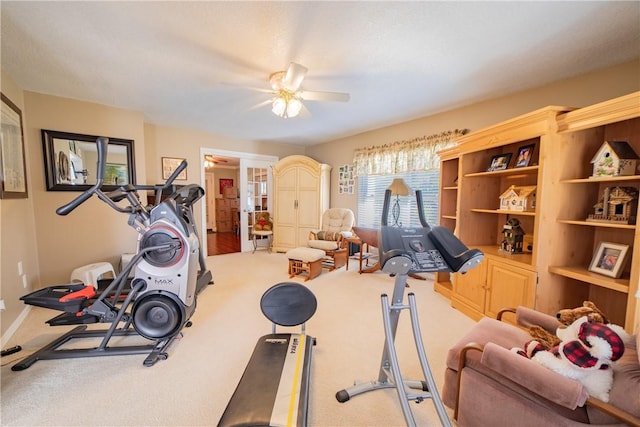 workout room featuring carpet flooring and a ceiling fan