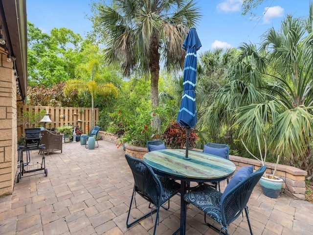 view of patio / terrace featuring fence and outdoor dining space