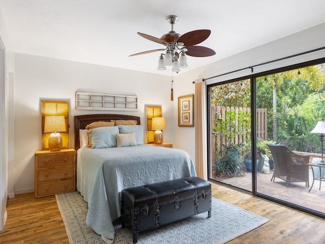 bedroom featuring access to exterior, ceiling fan, and wood finished floors