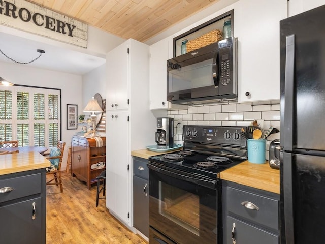 kitchen featuring tasteful backsplash, wooden counters, wood ceiling, white cabinetry, and black appliances