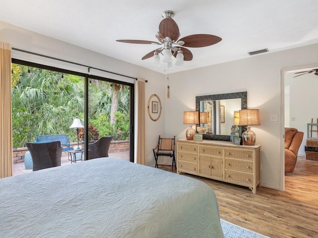 bedroom featuring ceiling fan, light wood-style flooring, visible vents, and access to exterior