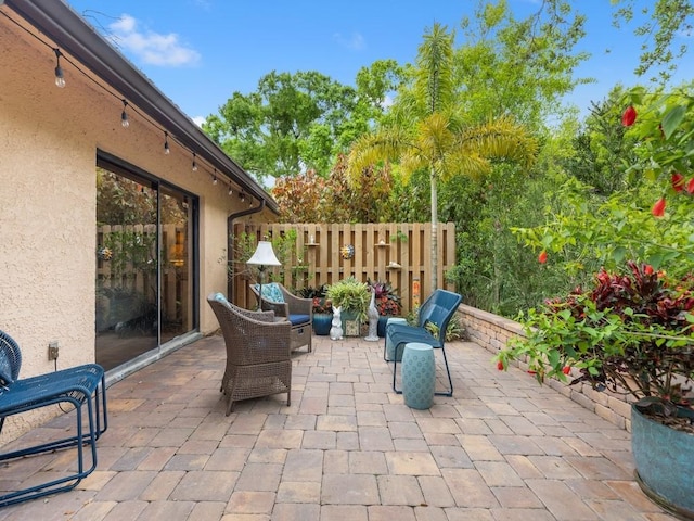 view of patio featuring fence