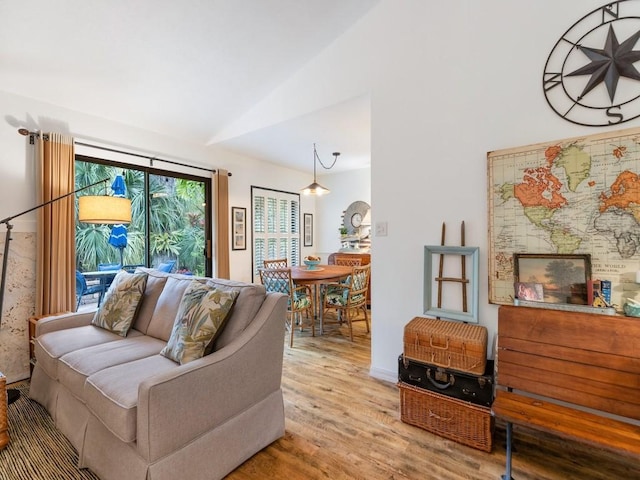 living room with vaulted ceiling and wood finished floors