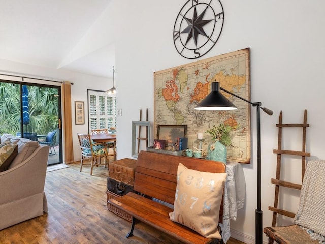 living area featuring lofted ceiling and wood finished floors