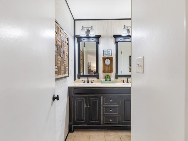 bathroom featuring double vanity, a sink, and tile patterned floors