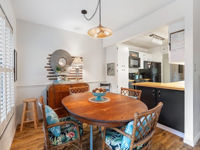 dining room featuring baseboards and wood finished floors