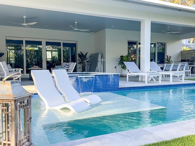 view of pool with ceiling fan, a patio area, and an in ground hot tub