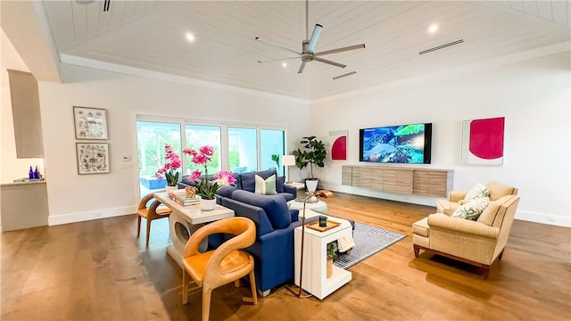 living room with ceiling fan, wood-type flooring, a towering ceiling, and wooden ceiling