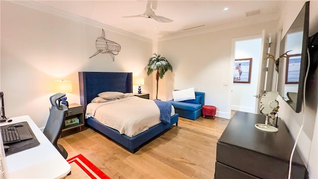 bedroom with ceiling fan, hardwood / wood-style floors, and ornamental molding