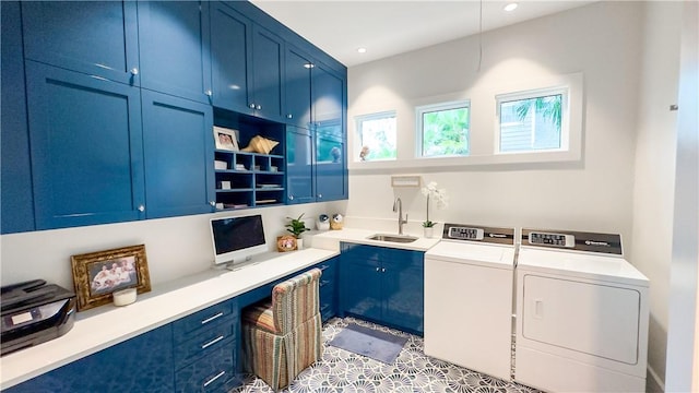 clothes washing area with independent washer and dryer, sink, and cabinets