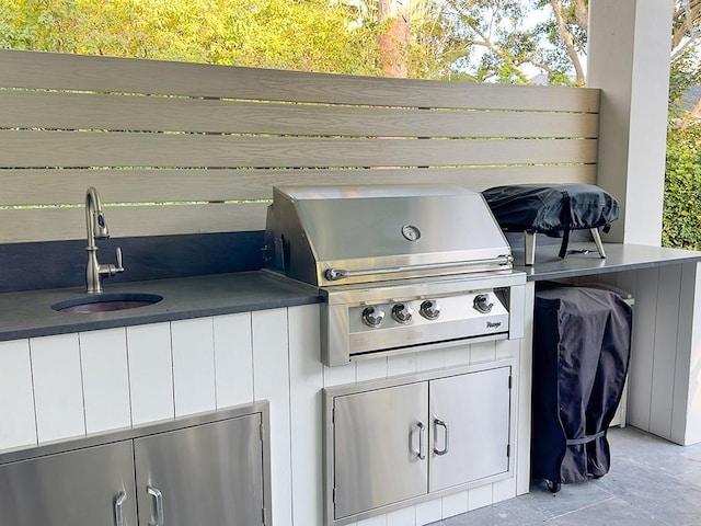 view of patio with a grill, an outdoor kitchen, and sink