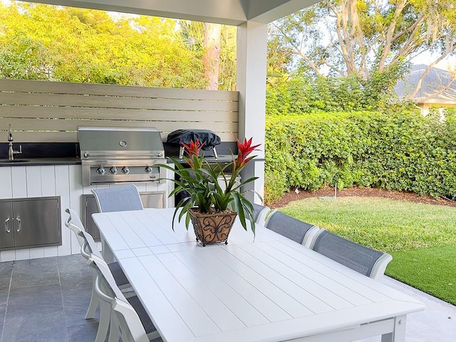 view of patio / terrace featuring grilling area, sink, and area for grilling