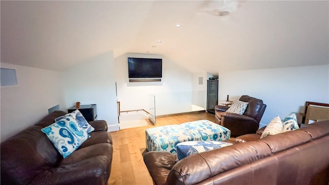 living room featuring light hardwood / wood-style flooring and lofted ceiling