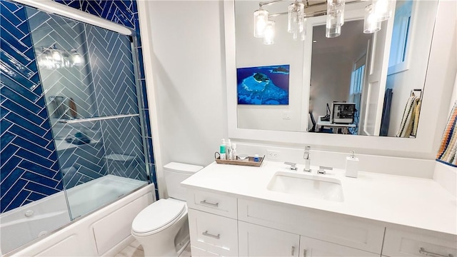 full bathroom with bath / shower combo with glass door, toilet, and vanity