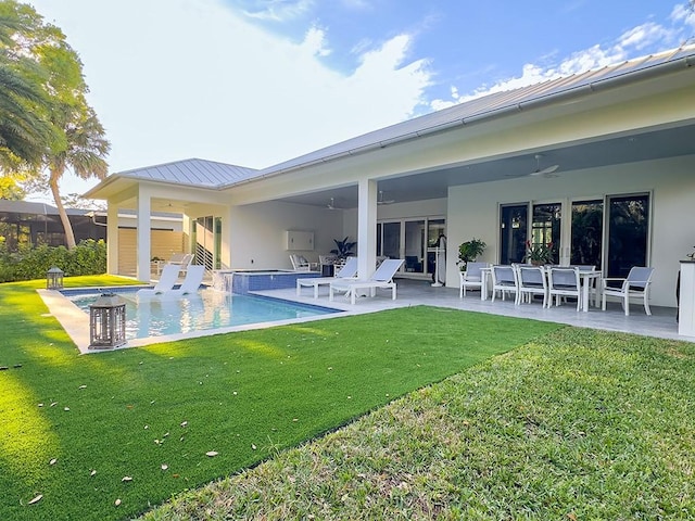 back of property with ceiling fan, a patio area, and a lawn