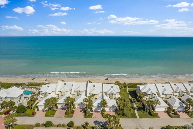 drone / aerial view featuring a water view and a view of the beach