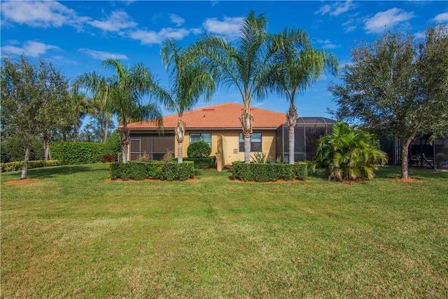 4487 Beauty Leaf Cir, Vero Beach, FL 32967 - rear view of property featuring a lawn, a tile roof, and stucco siding