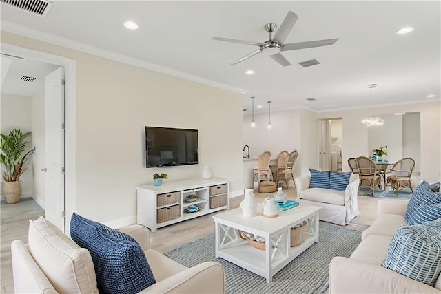 4487 Beauty Leaf Cir, Vero Beach, FL 32967 - living room featuring a ceiling fan, light wood-type flooring, recessed lighting, baseboards, and ornamental molding