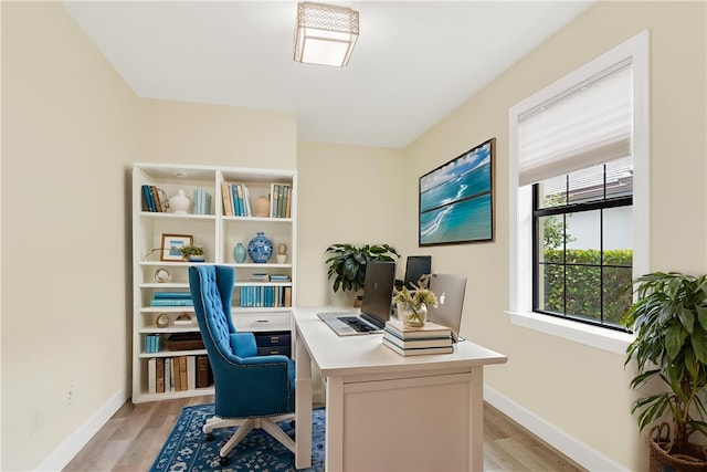 4487 Beauty Leaf Cir, Vero Beach, FL 32967 - home office with baseboards and light wood finished floors