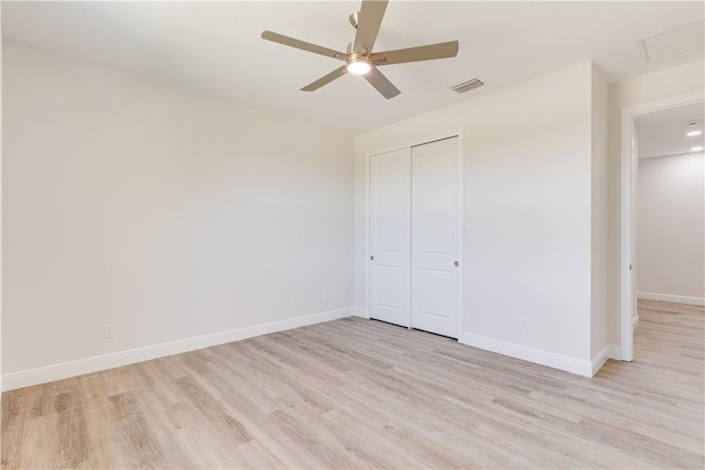 unfurnished bedroom with light wood-style floors, visible vents, and baseboards