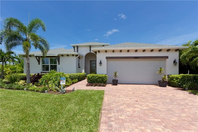 view of front of property featuring a garage and a front lawn