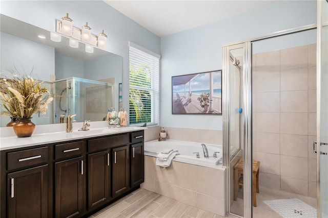 bathroom with vanity and independent shower and bath