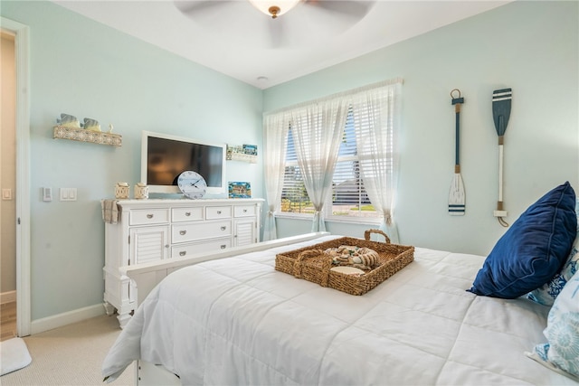 bedroom with light carpet and ceiling fan