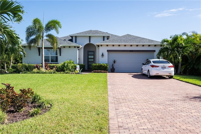 view of front of property featuring a garage and a front yard