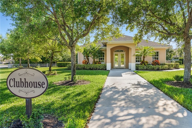 view of front of house featuring a front yard and french doors