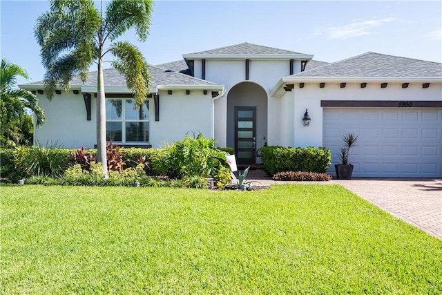 view of front of house with a garage and a front lawn