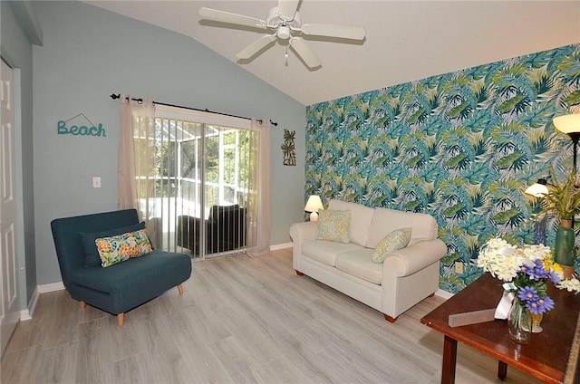 sitting room featuring vaulted ceiling, ceiling fan, and light wood-type flooring