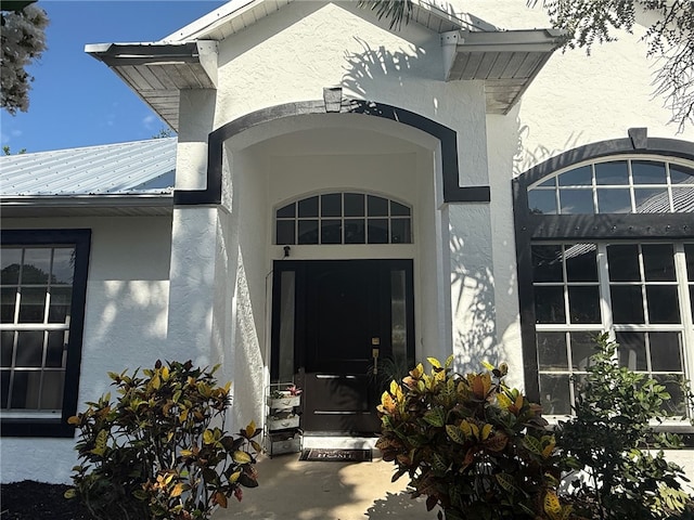 405 29th Ct SW, Vero Beach, FL 32968 - doorway to property with stucco siding and a metal roof