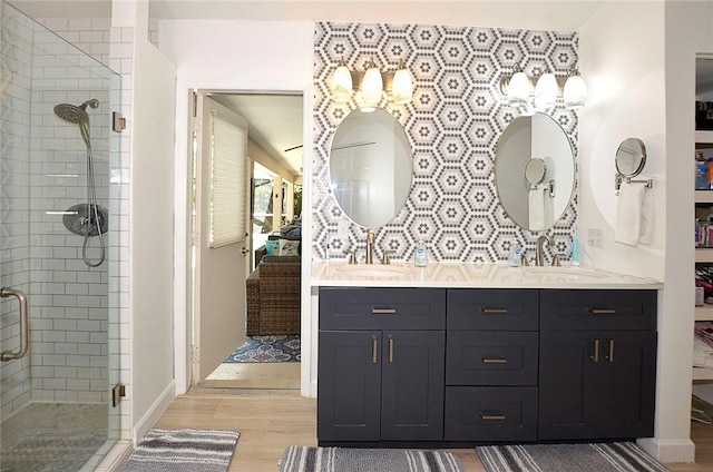 bathroom with a shower with door, vanity, and hardwood / wood-style flooring