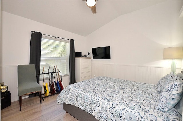 bedroom featuring ceiling fan, lofted ceiling, and light wood-type flooring