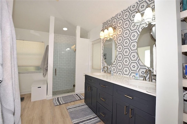 bathroom with wood-type flooring, an enclosed shower, and vanity