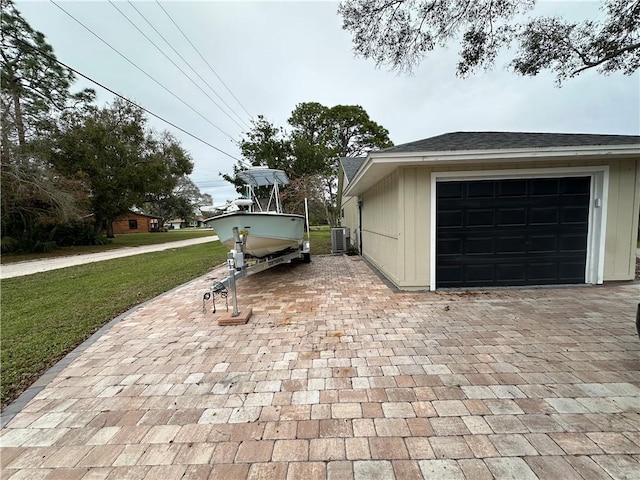 exterior space featuring central AC and a lawn