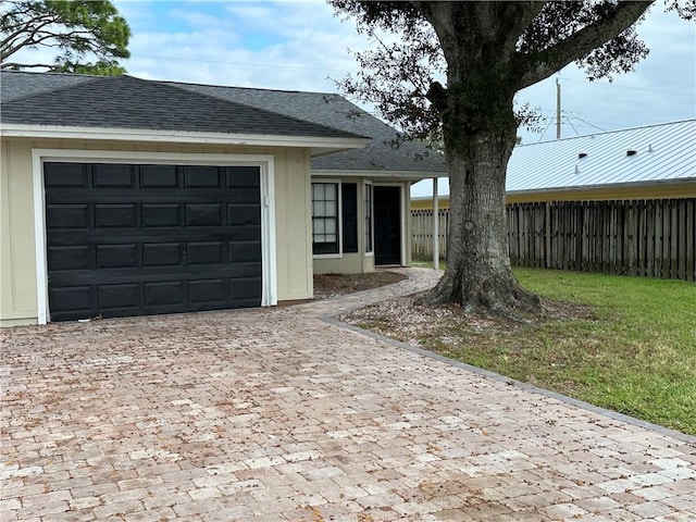 ranch-style home featuring a garage and a front yard