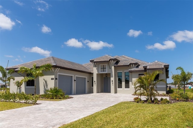 view of front of home featuring a garage and a front yard