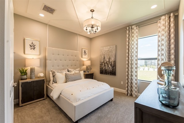 carpeted bedroom with a chandelier