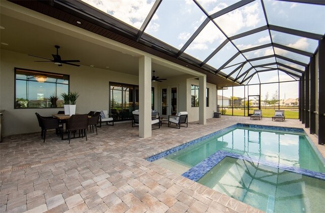 view of pool featuring a lanai, ceiling fan, an in ground hot tub, and a patio area