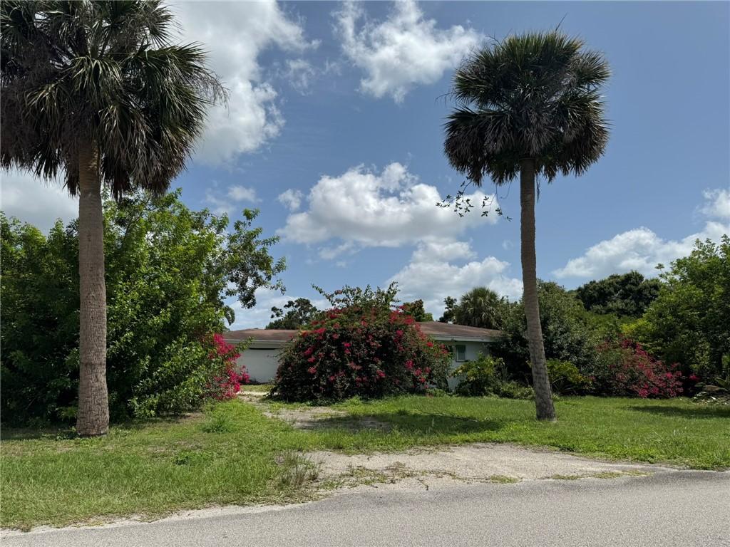 3010 11th Ave, Vero Beach, FL 32960 - view of property hidden behind natural elements with a front lawn