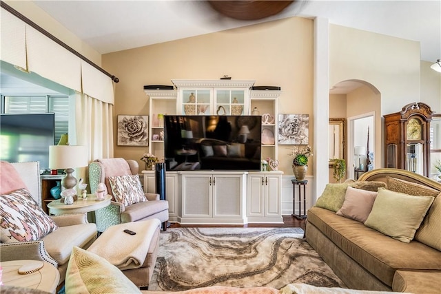 living room featuring lofted ceiling and wood-type flooring