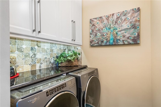 laundry area featuring independent washer and dryer and cabinets