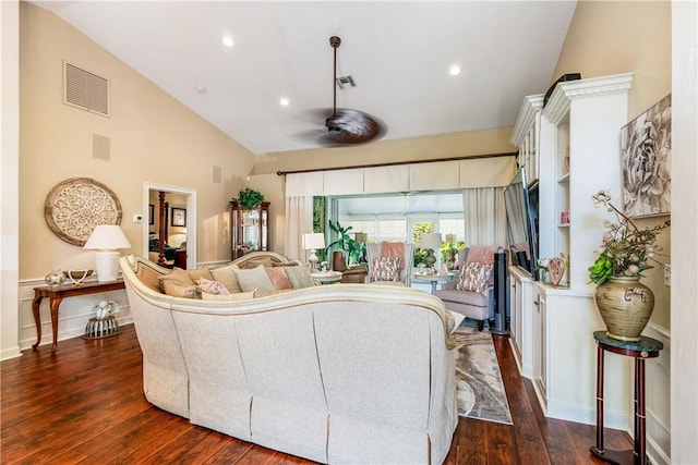 living room featuring dark hardwood / wood-style flooring, high vaulted ceiling, and ceiling fan