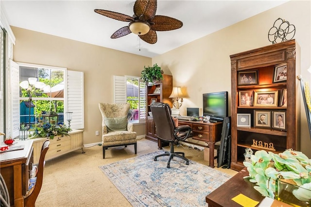 office area featuring light carpet and ceiling fan