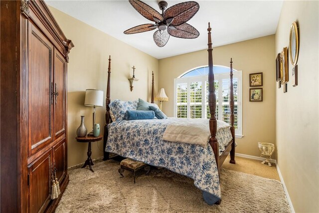 bedroom featuring light colored carpet and ceiling fan