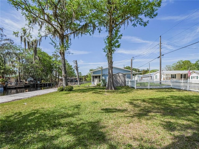 view of yard with an outbuilding and fence