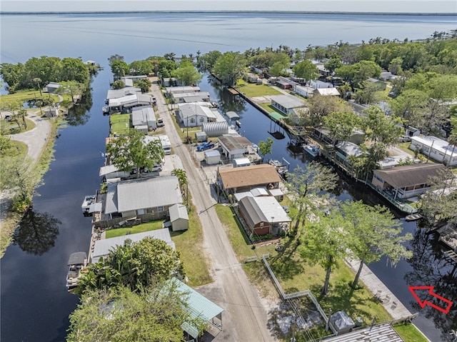 drone / aerial view with a residential view and a water view